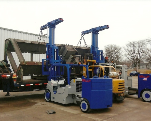 Our 2 Versa Lift forklifts unloading a large wheel press